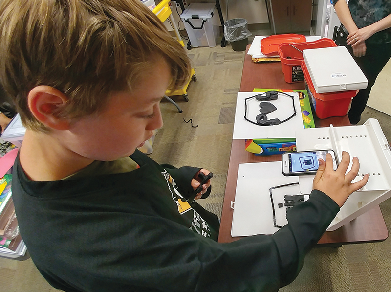 a child using a tactile-assisted device