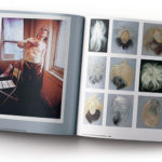 A is for Archive book open to a spread showing Andy Warhol's wig collection and a photo of him wearing a corset exposing scars from a surgery from being shot.