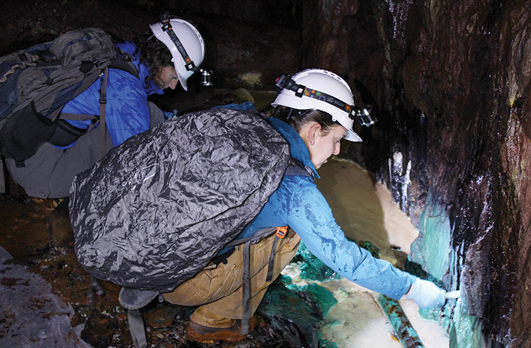 Two female scientists taking samples in a mine.