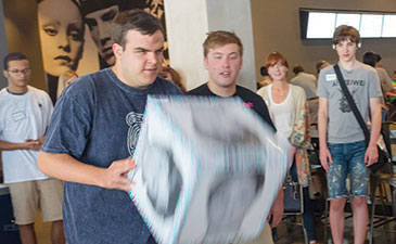 Matthew Rice participates in an activity focused on recognizing facial expressions.