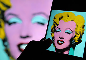 a mobile phone with an image of Warhol's painting of Marilyn Monroe