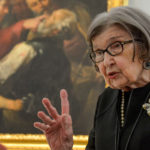 An art docent givinga tour to an elderly museum visitor
