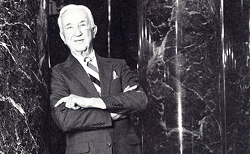 A portrait of of Joseph Fitzpatrick leaning against a column.