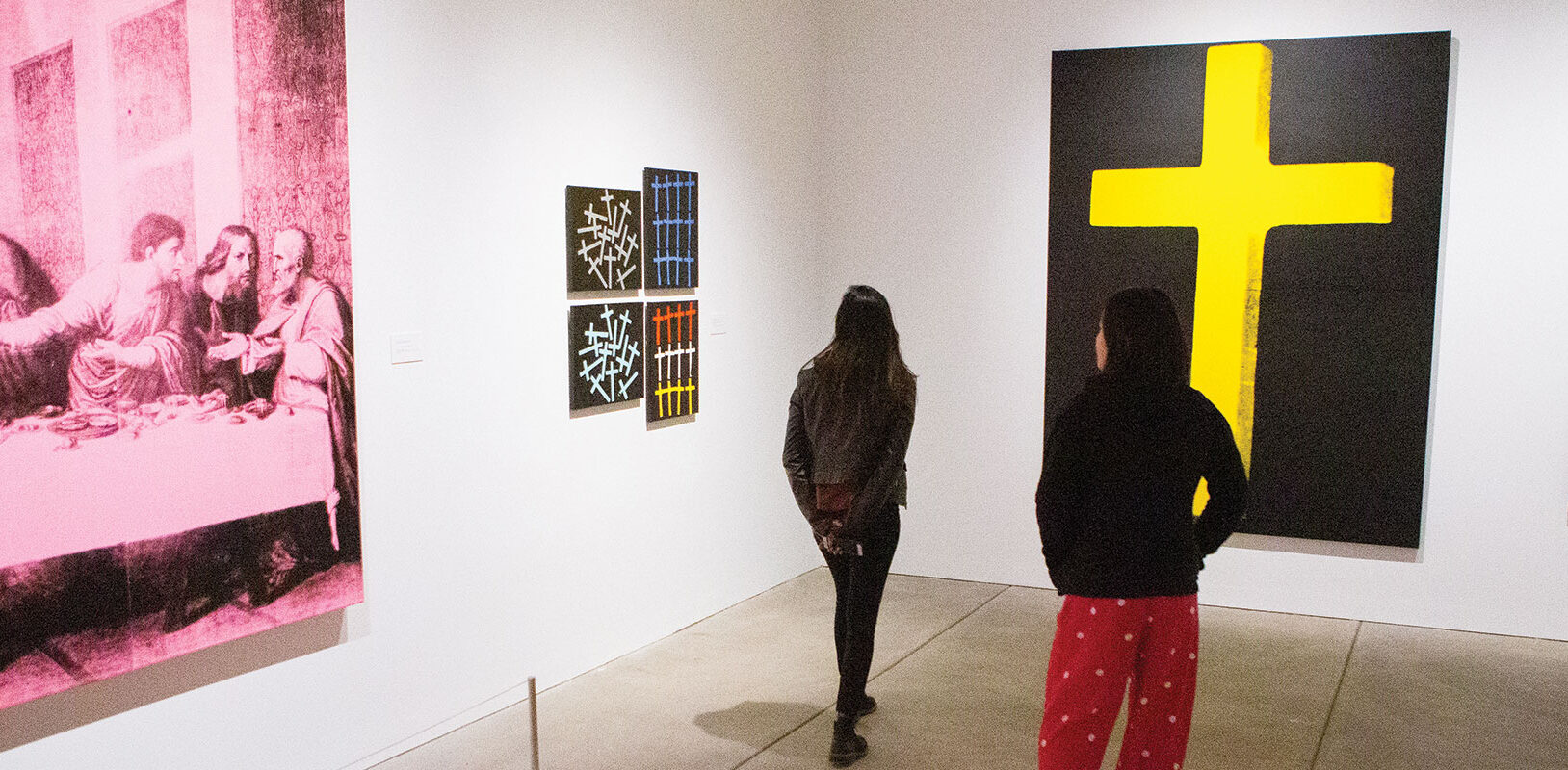Two teenage girls walking in a gallery at the Andy Warhol museum