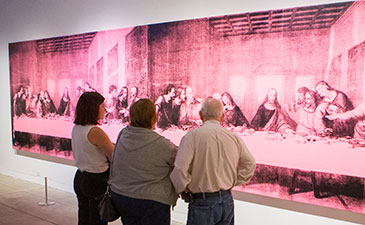 THree people standing in front of Andy Warhol's last supper
