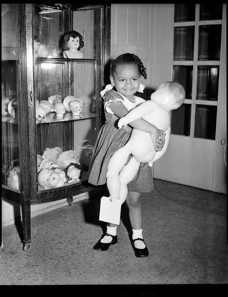 Girl holding doll