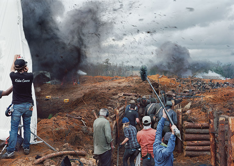 Photo of a film crew filming a battle scene for a movie