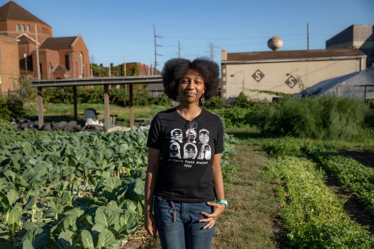 A young girl in an urban farm field