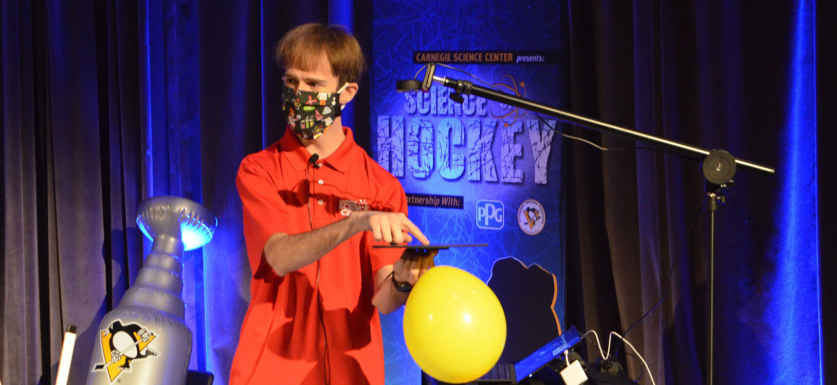 A man demonstrating a science experiment about hockey