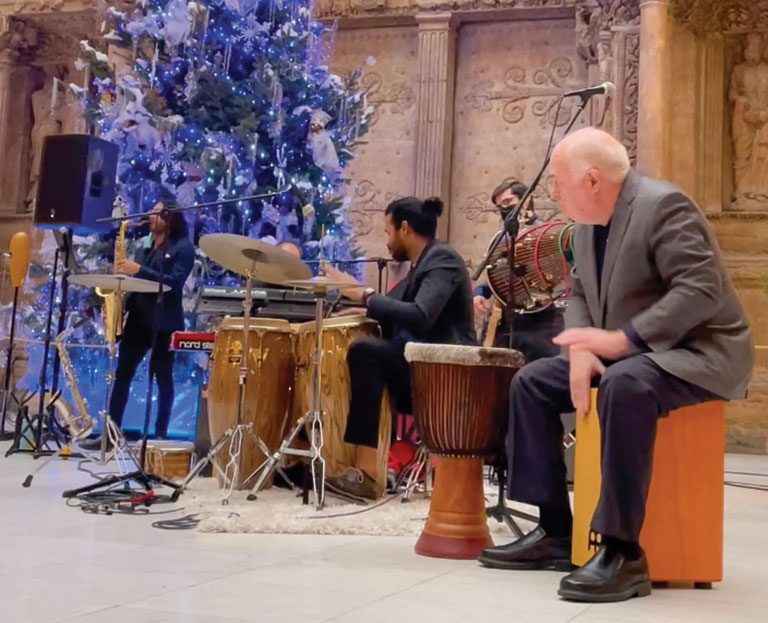 Museum president Steve Knapp playing percussion instruments with a band