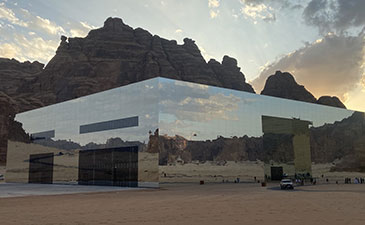 A mirrored building in the desert