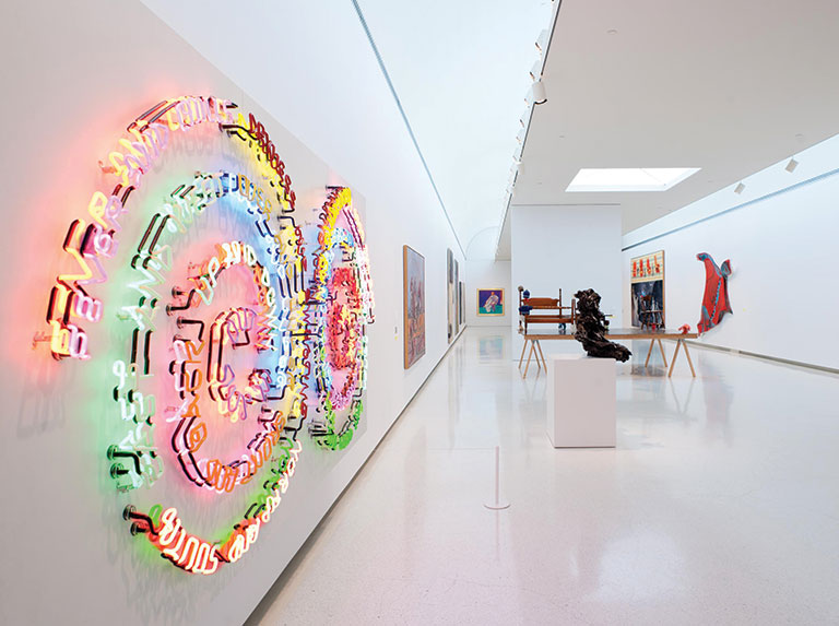An gallery installation view of a colorful neon artwork