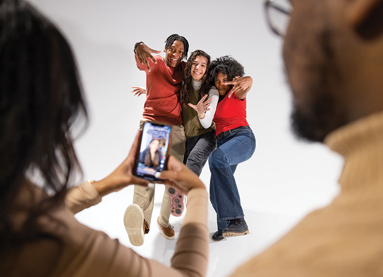 A group of teens posing for a tik-tok video