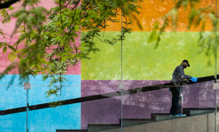 Custodian J.W. Williams, who has worked at Carnegie Museums for 38 years, sanitizes the handrail leading up to the Scaife Galleries at Carnegie Museum of Art.