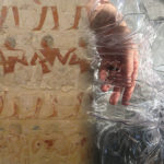 A beetle, hieroglyphics and a hand in plastic