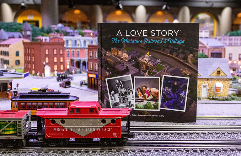 A book with the title, A Love Story, the Miniature Railroad and Village, setup in the miniature railroad