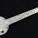 A vintage electric guitar made from aluminum.