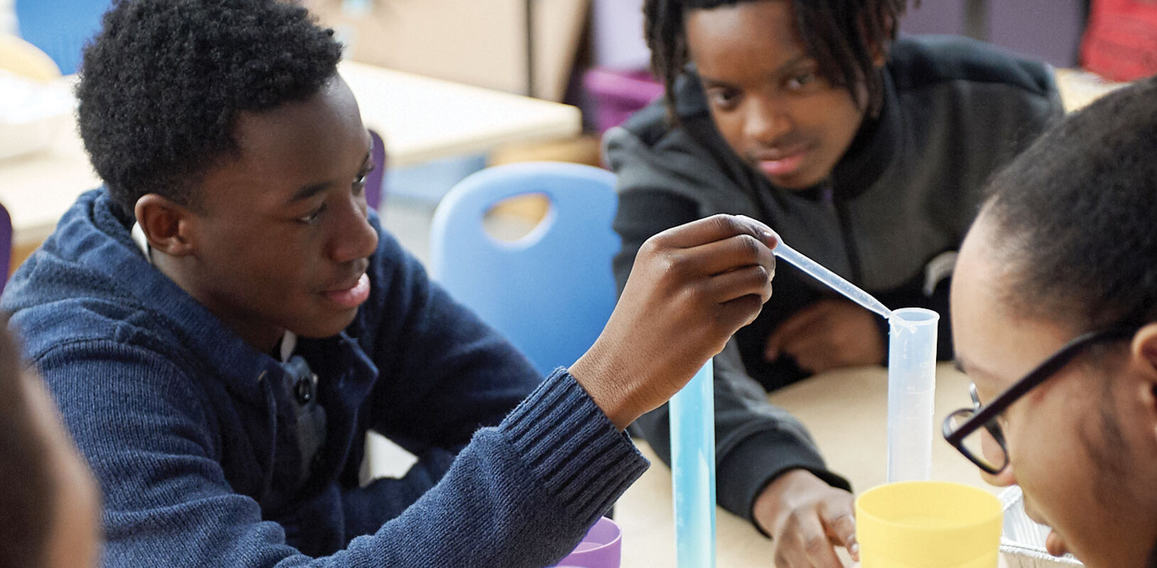 A group of teens engaged in a science experiment