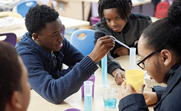 A group of teens engaged in a science experiment