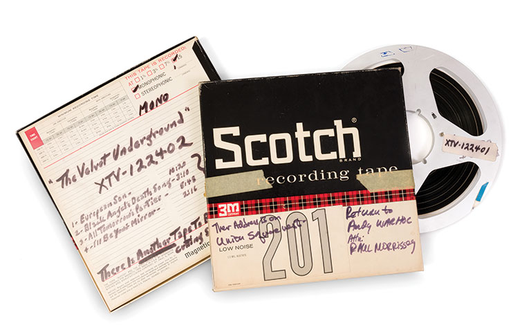 The front and back of Scotch reel-to-reel tape boxes with a reel-to-reel sticking out of the side of it.