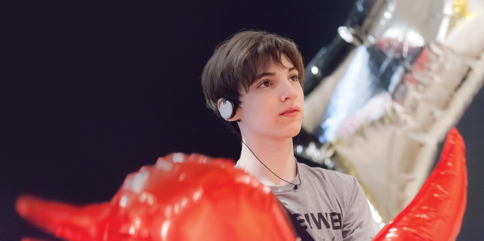 A young man with sound-control earphones taking part in a sensory-friendly event