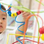 preschool child working on a puzzle