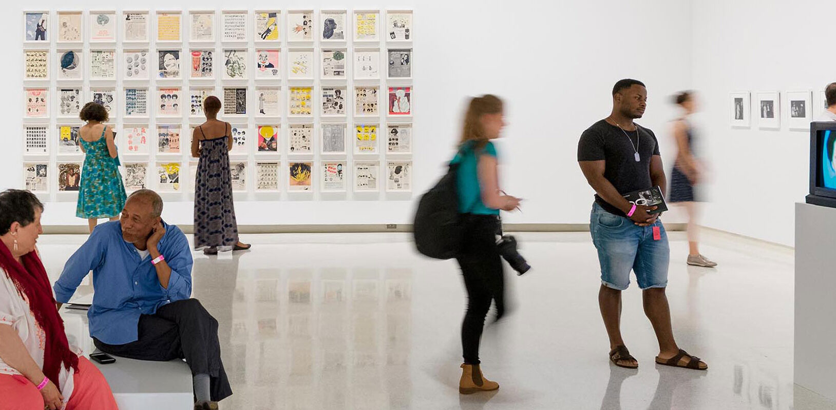People viewing an exhibit in the art museum.