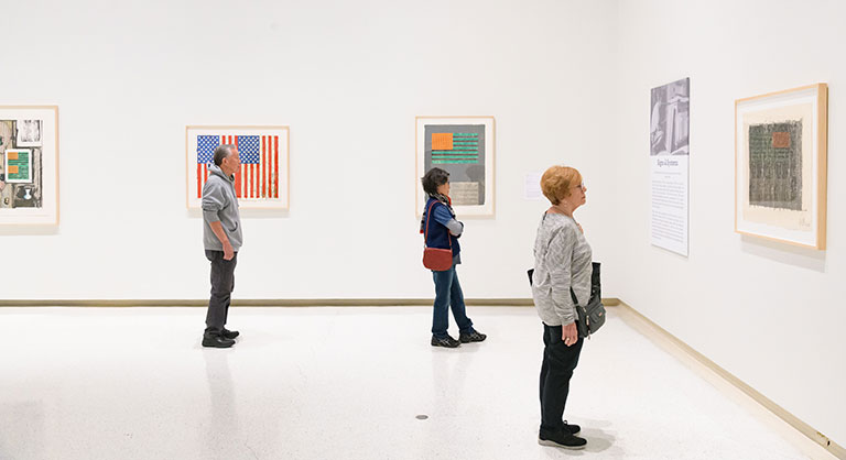 People exploring the art museum exhibition.