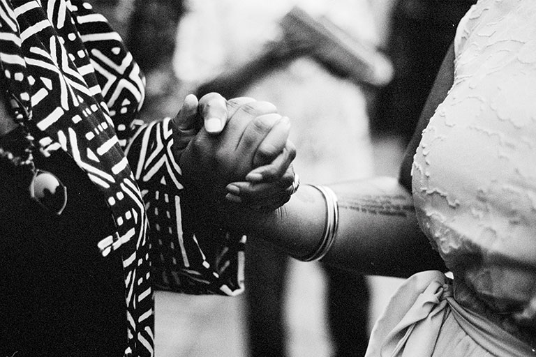 A photo fo two woman's hands clasped together.