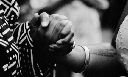 A photo fo two woman's hands clasped together.