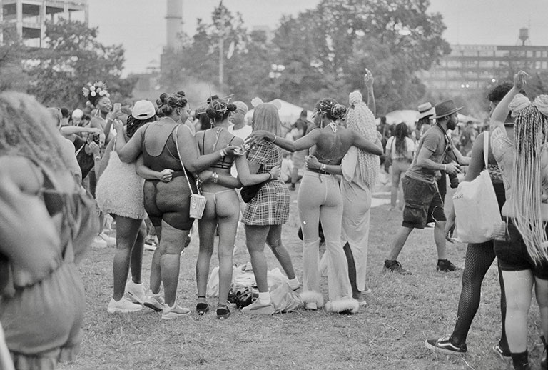 A group of African-American women huddling together outdoors.