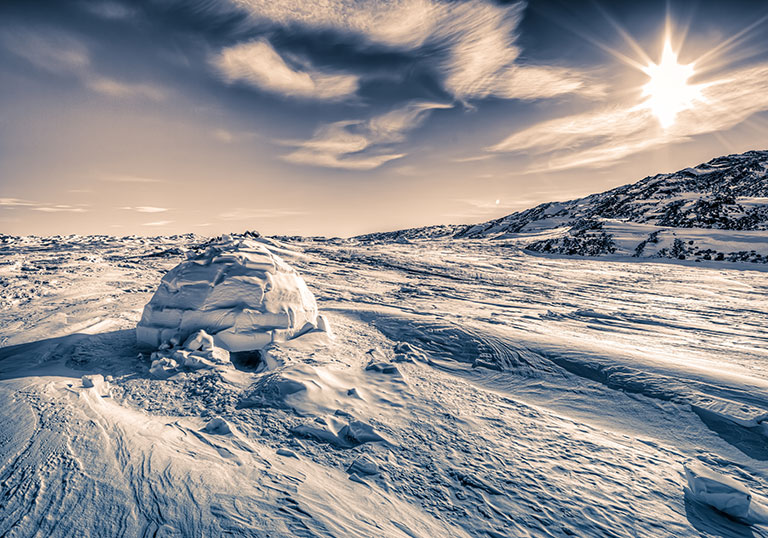 A scene showing a snowy piece of land an an igloo