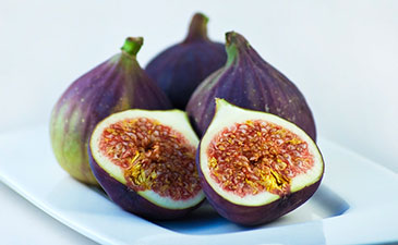 A group of figs on a plate