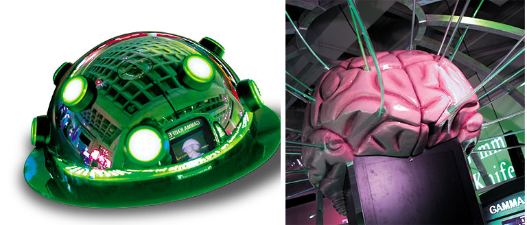 Green robot-like contraption and a large model of a human brain.
