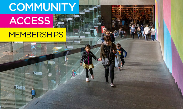 A family walking up the stairs at a museum with the words communit access memberships over top of the photo