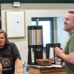A group of people talking and laughing in a coffee shop