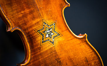 A violin with the star of David inlaid on the back of it.